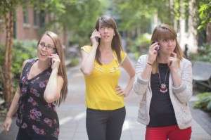 female employees using cell phones for leadership communication 