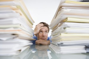 employee looking at stack of paper