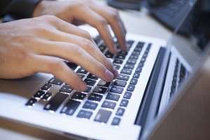 business laptop typing internal communication tool 