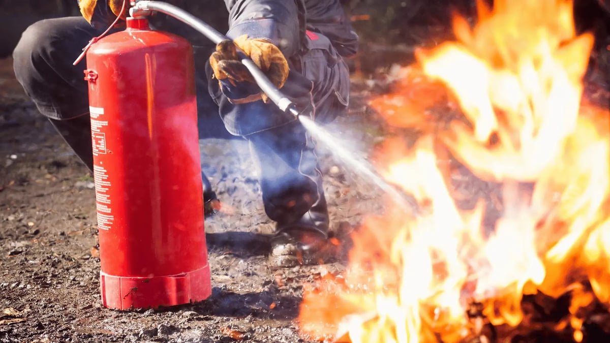 man using a fire extinguisher