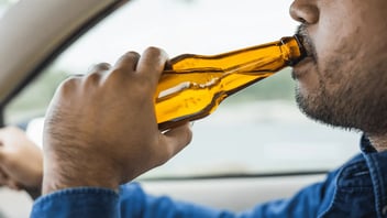 man drinking while driving