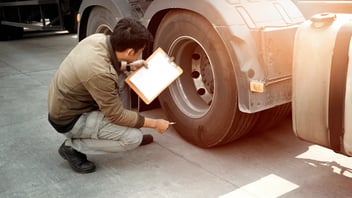man working on inspection of vehicle