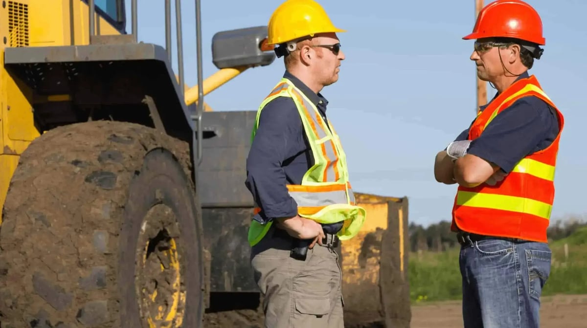 two workers talking about safety