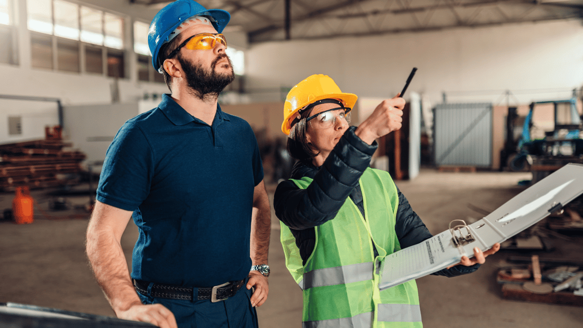 employees looking at something in warehouse