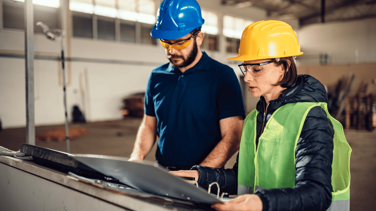 two workers performing safety tasks