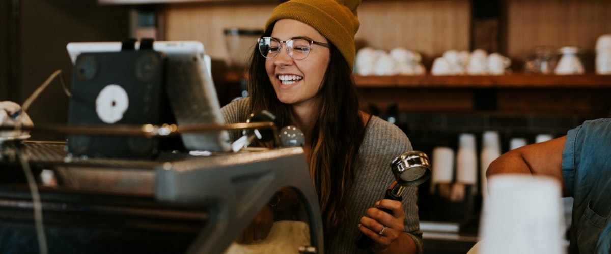 a new female employee watching an onboarding video from a boss