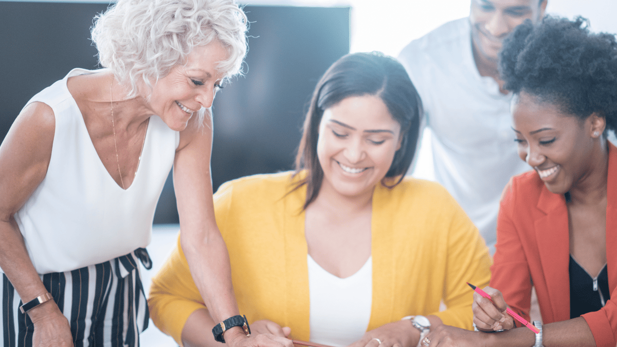a range of employees happily working