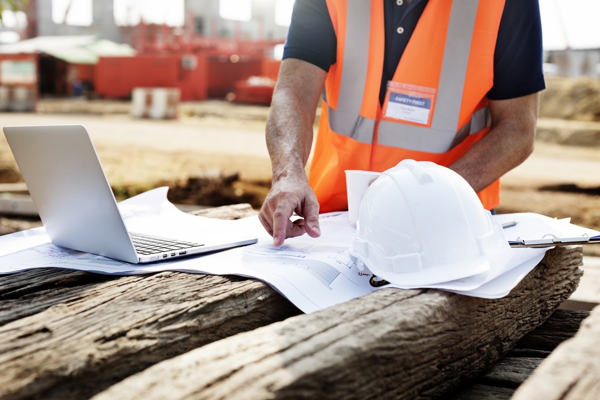 man looking at blueprint on the jobsite
