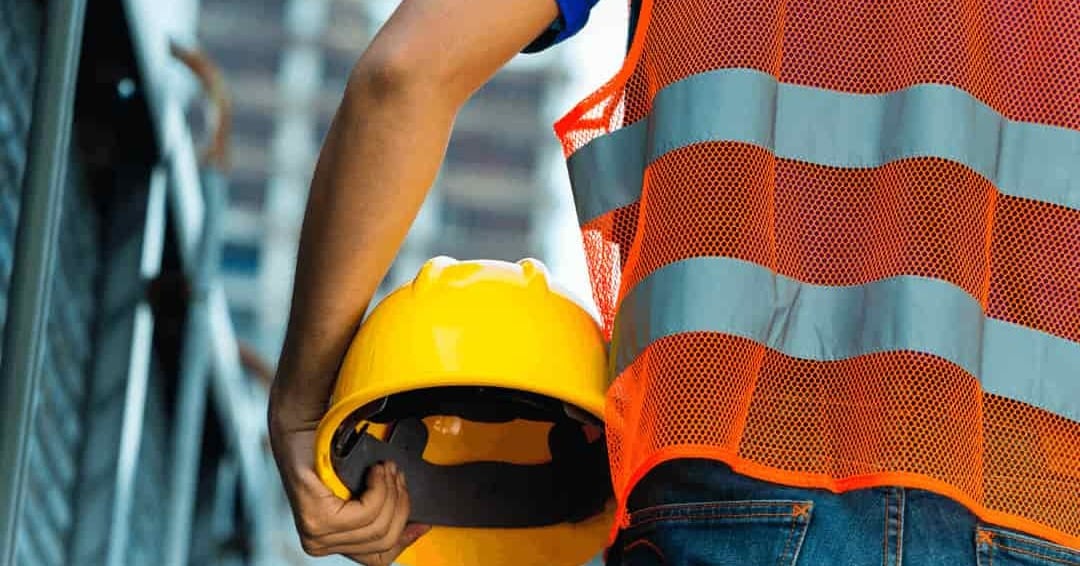 worker holding hard hat