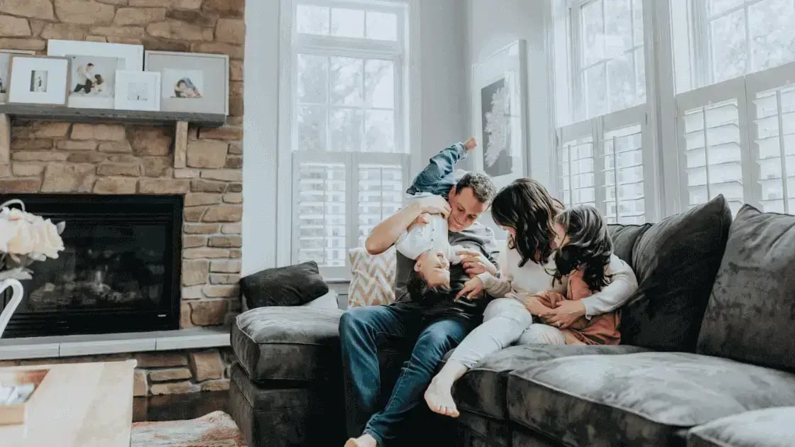 family playing on a couch in their home