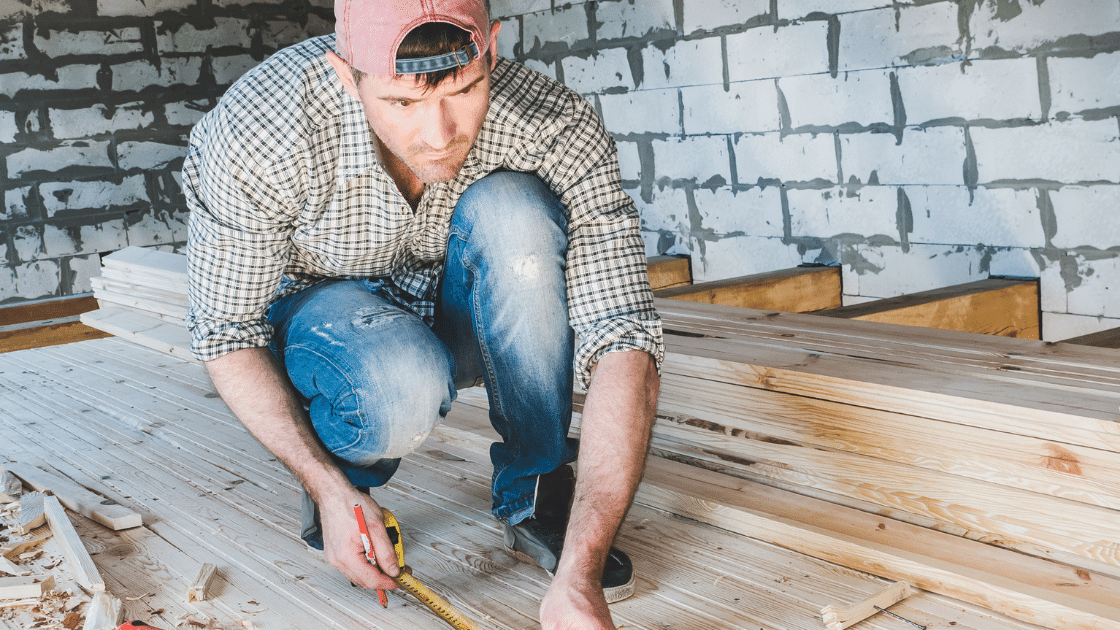man measuring for woodworking project
