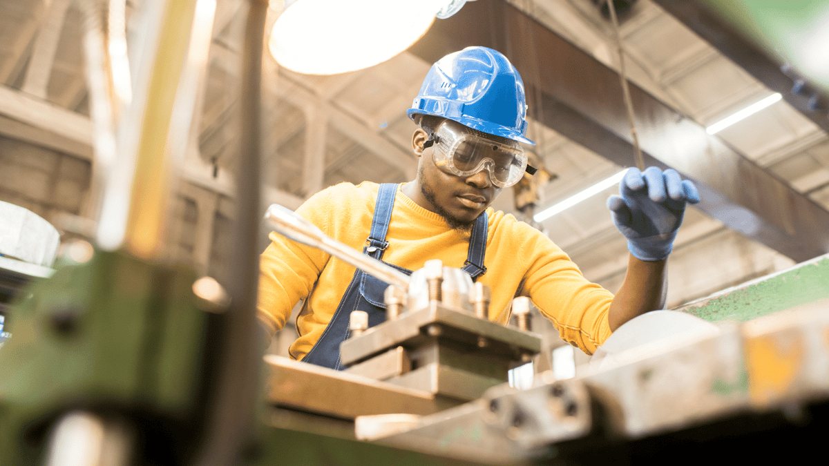 man working on the manufacturing floor wearing PPE
