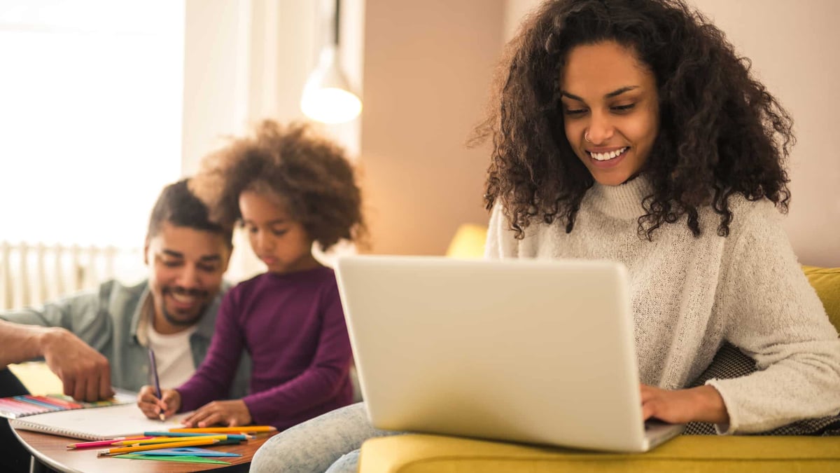 mother working from home with child doing school work