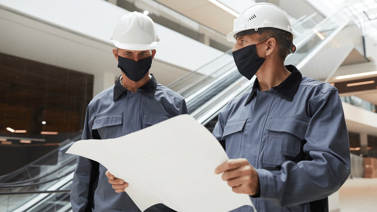two electrical workers wearing masks