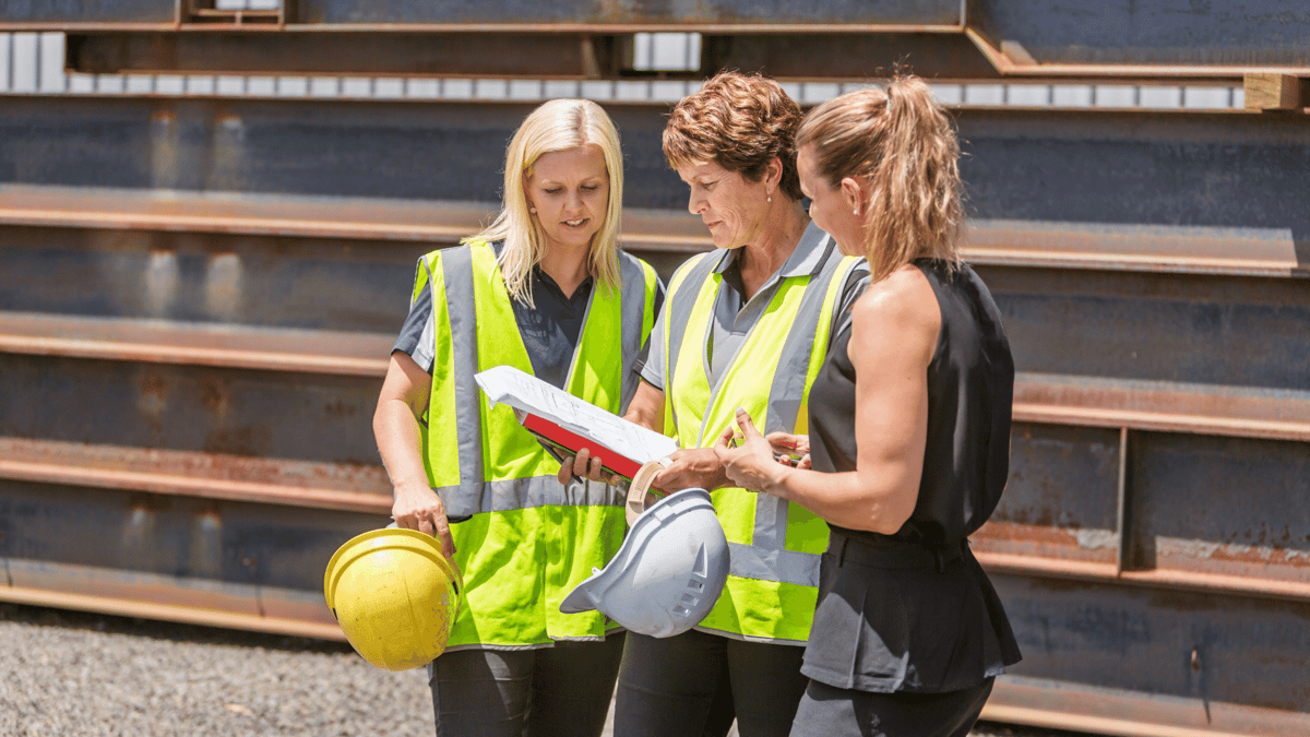 women on the job site reviewing safety material