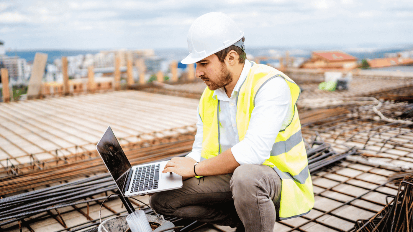 construction worker looking on computer