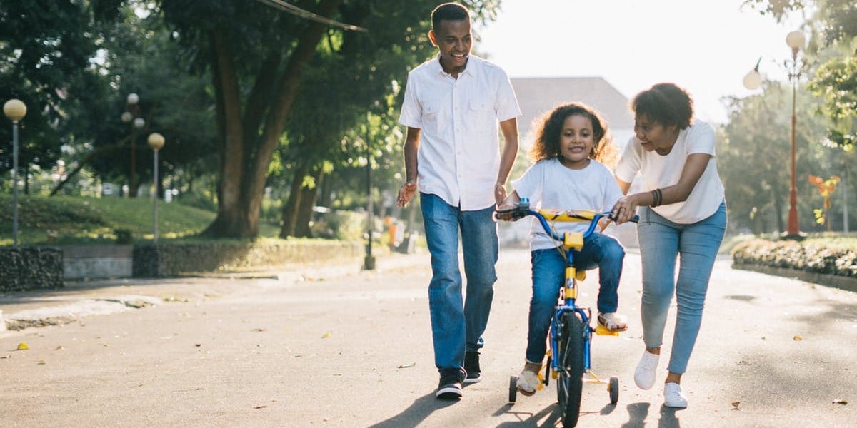 parents teaching kid bike riding - generational knowledge transfer - september 2018
