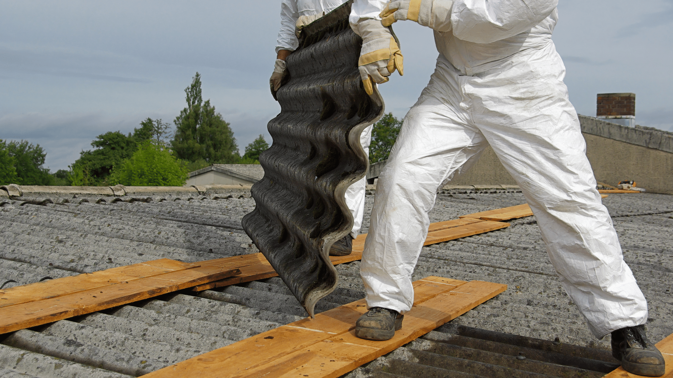 two employees working with asbestos