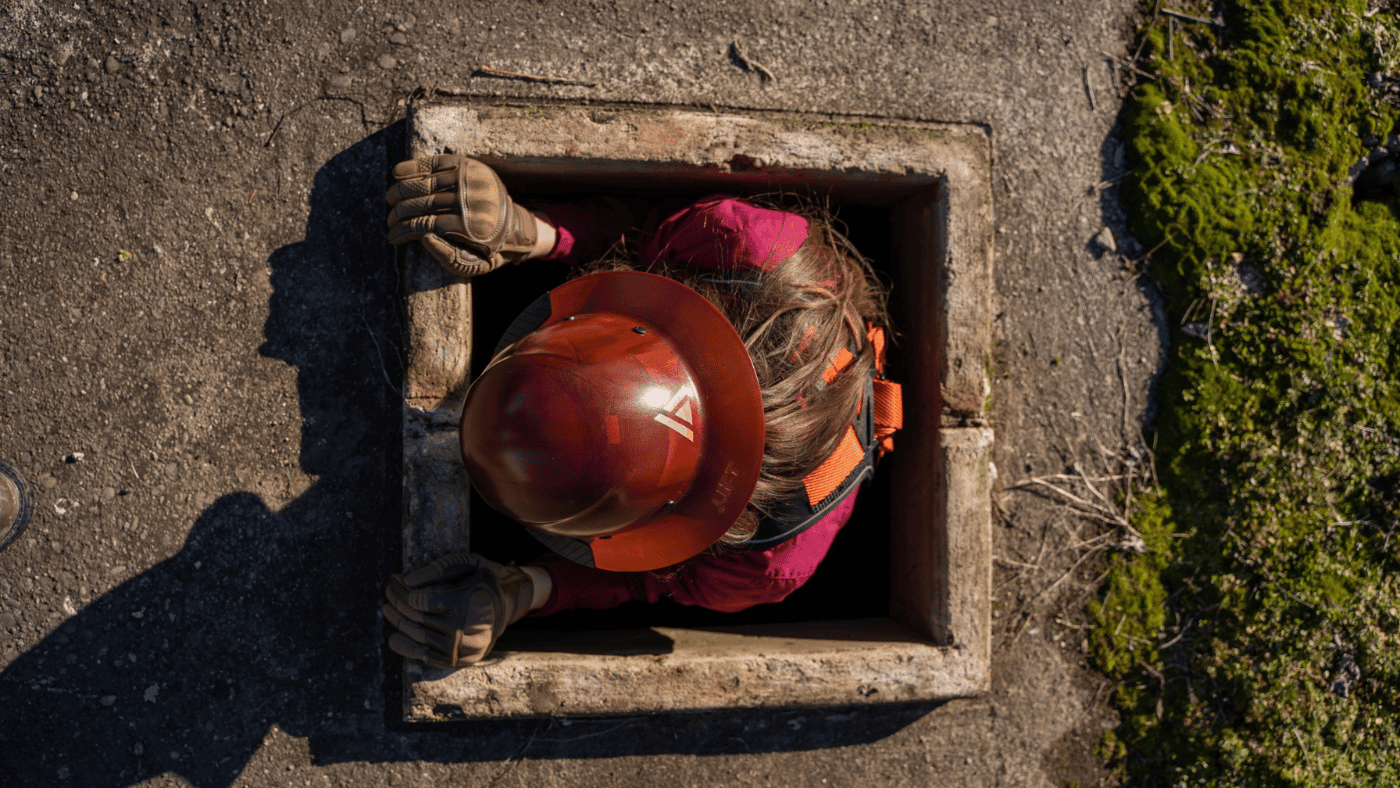 woman climbing in a man hole - blog image